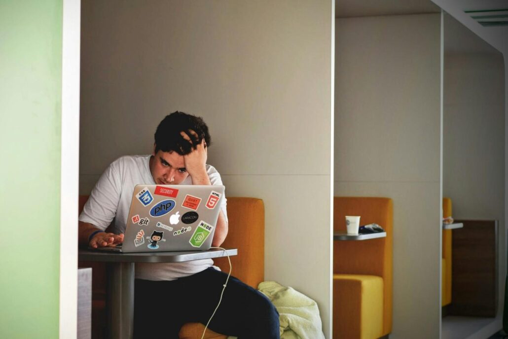 A man looking at a laptop screen at an addiction treatment center Idaho