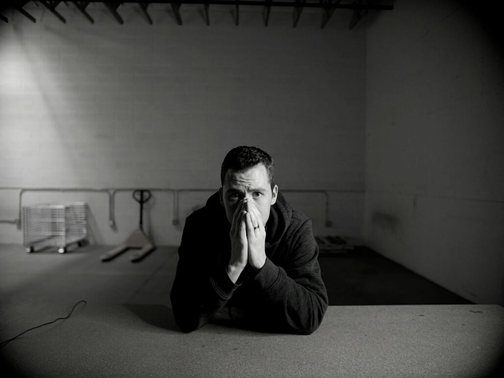 A man covering his face at an addiction treatment center Idaho