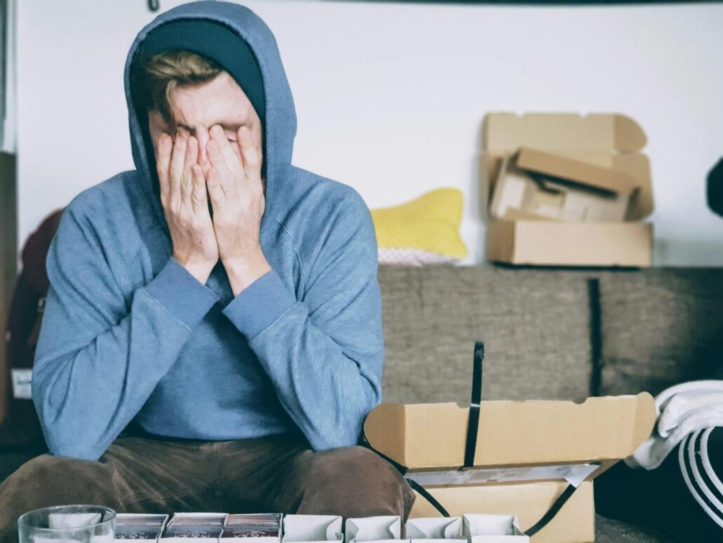 mental health: A man covering his face at a addiction treatment center 